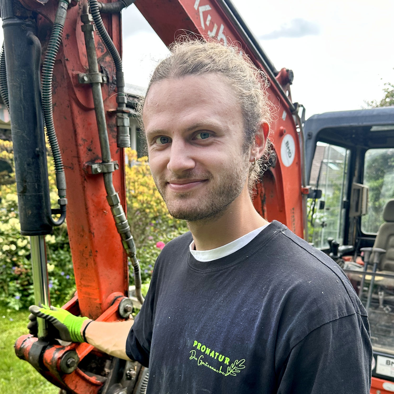 Mitarbeiter GArtenbau vor BAgger